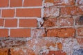 A fragment of an old red brick wall. Wall restoration site with new bricks Royalty Free Stock Photo