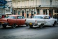 Fragment of old retro vintage classic old cars driving on authentic Cuban Havana city streets toward traffic lights