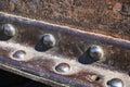 Metal detail riveted with rivets close-up. Royalty Free Stock Photo