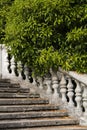 Fragment Old stone balustrade of railing background of green trees. Classic design and architecture. A picturesque Royalty Free Stock Photo