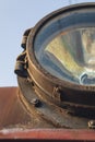 Fragment of old train headlight. Old rusty locomotive, close up. Royalty Free Stock Photo