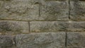 A fragment of an old wall made of neatly folded white-gray stone of different sizes. Royalty Free Stock Photo