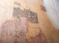 Fragment of an old wall with ragged wallpaper and old communist newspapers