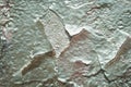 Fragment of an old wall with silver paint. Stucco texture`s background. Peeling of silver paint Royalty Free Stock Photo