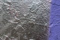 Fragment of an old wall with silver and violet paints. Peeling of silver paint. Space for text Royalty Free Stock Photo