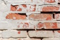 Fragment of old whitewashed brick wall with partially chipped plaster Royalty Free Stock Photo