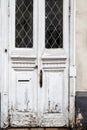 A fragment of an old wooden door with peeling paint. Selective focus Royalty Free Stock Photo