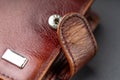 Fragment of an old worn wallet made of genuine leather.