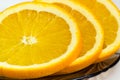 Fragment of orange slices on a glass saucer closeup Royalty Free Stock Photo