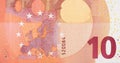 Fragment part of 10 euro banknote close-up with small red details