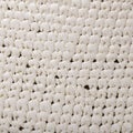 Fragment of patterned dense fabric made of white synthetic thread