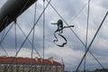 A fragment of a pedestrian bridge Bernatek Bridge of Love in Krakow with a sculpture of an acrobat ribbon