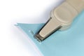 Fragment of pen type staple remover on stapled blue sheets Royalty Free Stock Photo