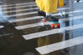 A fragment of a penny board at a pedestrian crossing. close-up