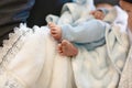 A fragment of a photograph of a little boy preparing for a baptismal ceremony, legs on a white blankets, baptism Royalty Free Stock Photo