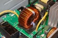 Fragment of a powerful power supply circuit, inductance coil close-up Royalty Free Stock Photo