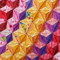 Fragment of quilt sewn from diamonds and has view three-dimensional