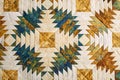 Fragment of quilt stitched from pineapple pattern blocks, traditional patchwork