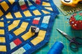 Fragment of a quilt, surrounded by tools for quilting Royalty Free Stock Photo