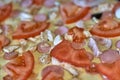 Fragment of raw pizza with tomatoes, cheese and olives, background and texture