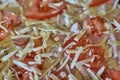 Fragment of raw pizza with tomatoes, cheese and olives, background and texture