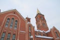 Fragment of a red brick church with windows and gilded roof Royalty Free Stock Photo