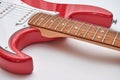 Fragment of a red electric guitar on a white background. Part of the guitar. Music object