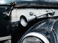 Fragment of a retro car with a signal horn outside and splattered with mud Royalty Free Stock Photo