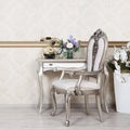 A fragment of a retro interior with a chair and a desk on which is located a telephone and a vase of flowers Royalty Free Stock Photo