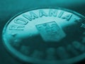 Fragment of a Romanian 50 bani coin. Inscription Romania closeup. News about economy or banking. Loan and credit. Wages and taxes