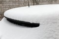 Fragment of the roof and back of parked snowbound car