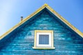 Fragment of roof of old wooden house with iron chimney and plastic window with white frame. Holes and gaps between boards. Rustic Royalty Free Stock Photo