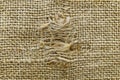 A fragment of a rough canvas burlap with a hole Royalty Free Stock Photo