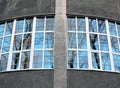 Fragment of roundish wall with big windows overlooking park