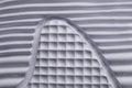 Fragment of a rubber white sole of a sneaker.