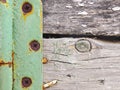 Fragment of a rustic gate in a fence close-up. Old gray weathered wooden beams and door hinge. Vintage illustration or background Royalty Free Stock Photo