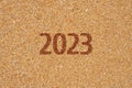 Fragment of a sandy beach with the inscription 2023