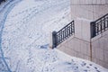 A fragment of the snow-covered city embankment of the Amur River. Winter morning. Metal and granite