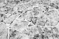 A fragment of a snow-covered road from a flat stone as the basis of the background. Royalty Free Stock Photo