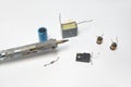 Fragment of soldering iron and several components of electronics