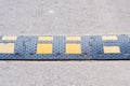 Fragment of a speed bump on blurred asphalt road background Royalty Free Stock Photo