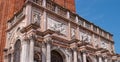 Fragment of St Mark`s Campanile - famous bell tower of St Mark`s Basilica and Loggetta. Piazza San Marco, Venice, Italy