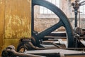 Fragment of steam generator used for steam engines in historical factory from 1903. Huge flywheel and yellow casing of the