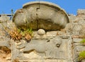 Fragment of stone wall of ruins of fortress of St. John with image of lion, Kotor, Montenegro