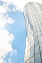 Fragment of a stylish modern high-rise building in St. Petersburg against the blue sky with clouds.  The building has a glazed Royalty Free Stock Photo