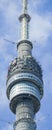 Fragment of a telecommunications tower against a blue sky with snow-white clouds.  Radio and satellite pole. Communication Royalty Free Stock Photo