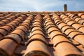 Fragment of a tiled old roof with a chimney on a blue sky background. Royalty Free Stock Photo