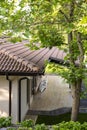 A fragment of a tiled roof of a bungalow in the woods. Royalty Free Stock Photo