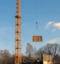 Fragment of a tower of a lifting tower crane and the moved freight Royalty Free Stock Photo