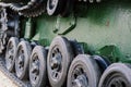 Fragment of a tracked track on green camouflage tank